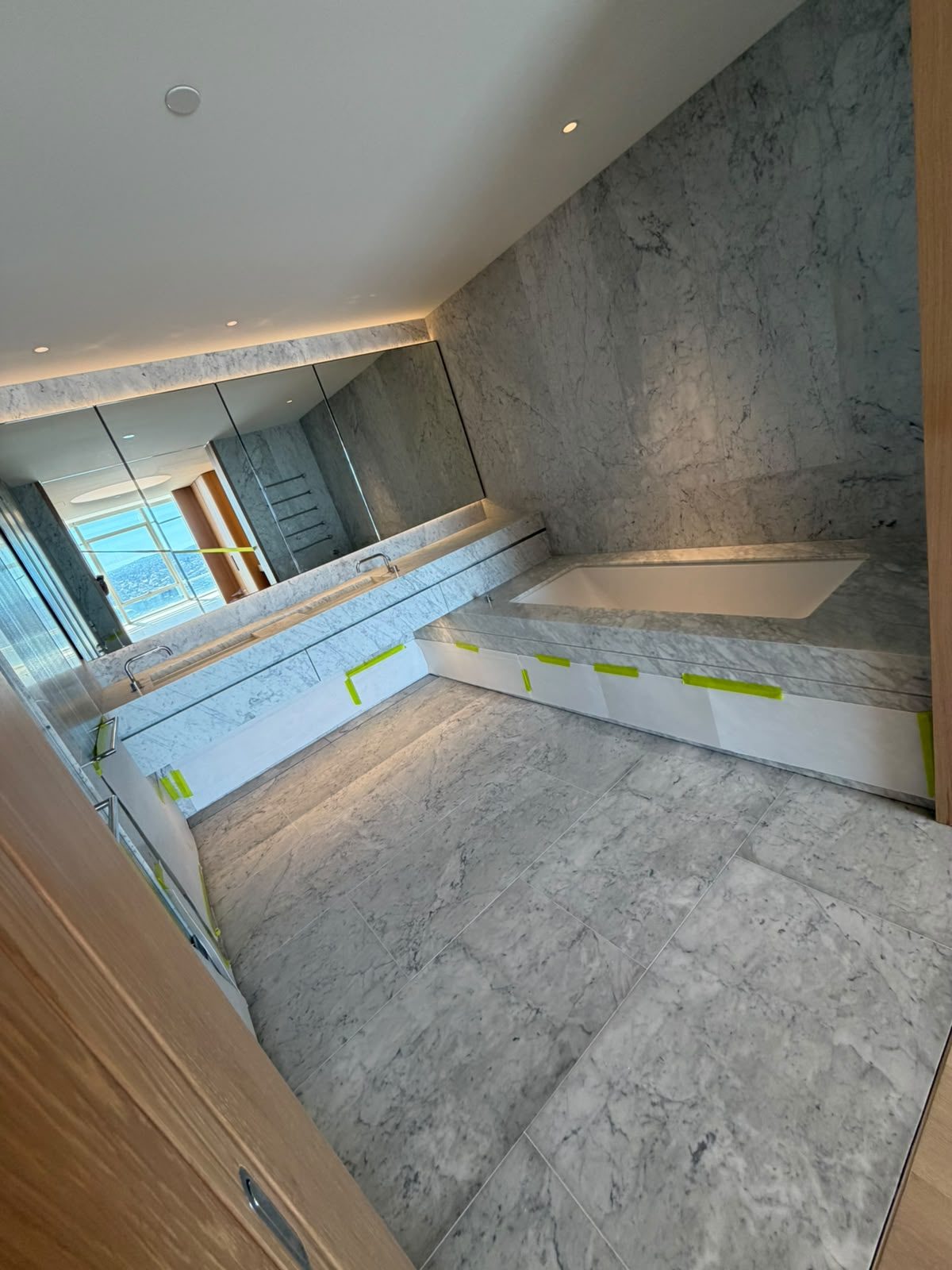 Bathroom renovation by Alta-Reno Services — freestanding bath with marble surround