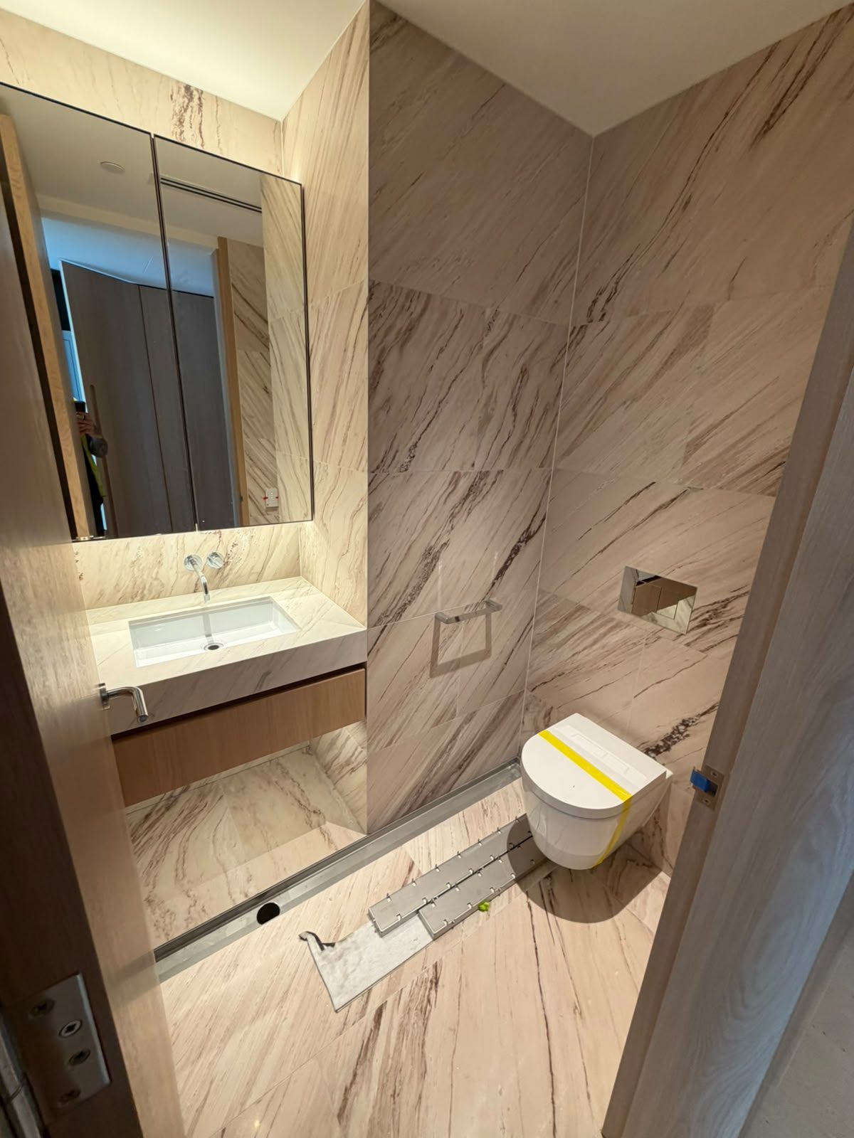 Bathroom renovation by Alta-Reno Services — marble wall tiling and toilet