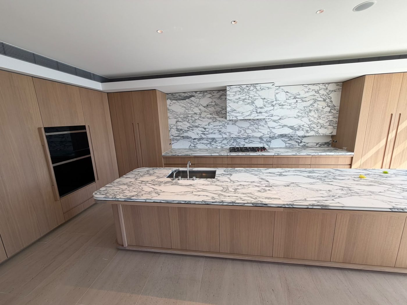 Kitchen renovation by Alta-Reno Services — island benchtop and marble splashback
